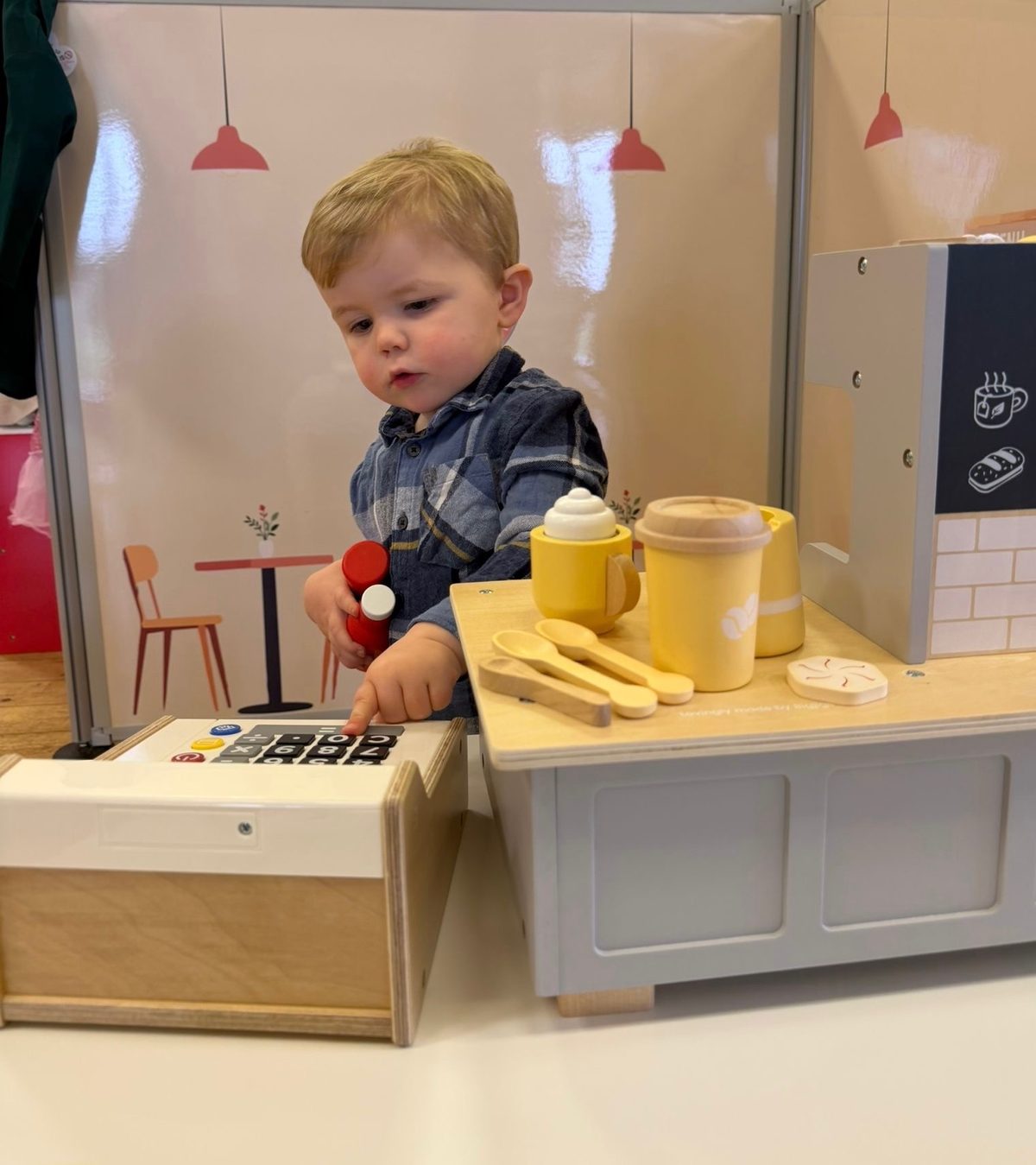 Child playing at the cafe till