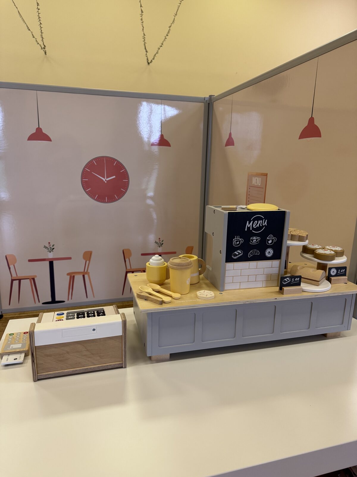 The Toddler Town cafe with till menu and cakes