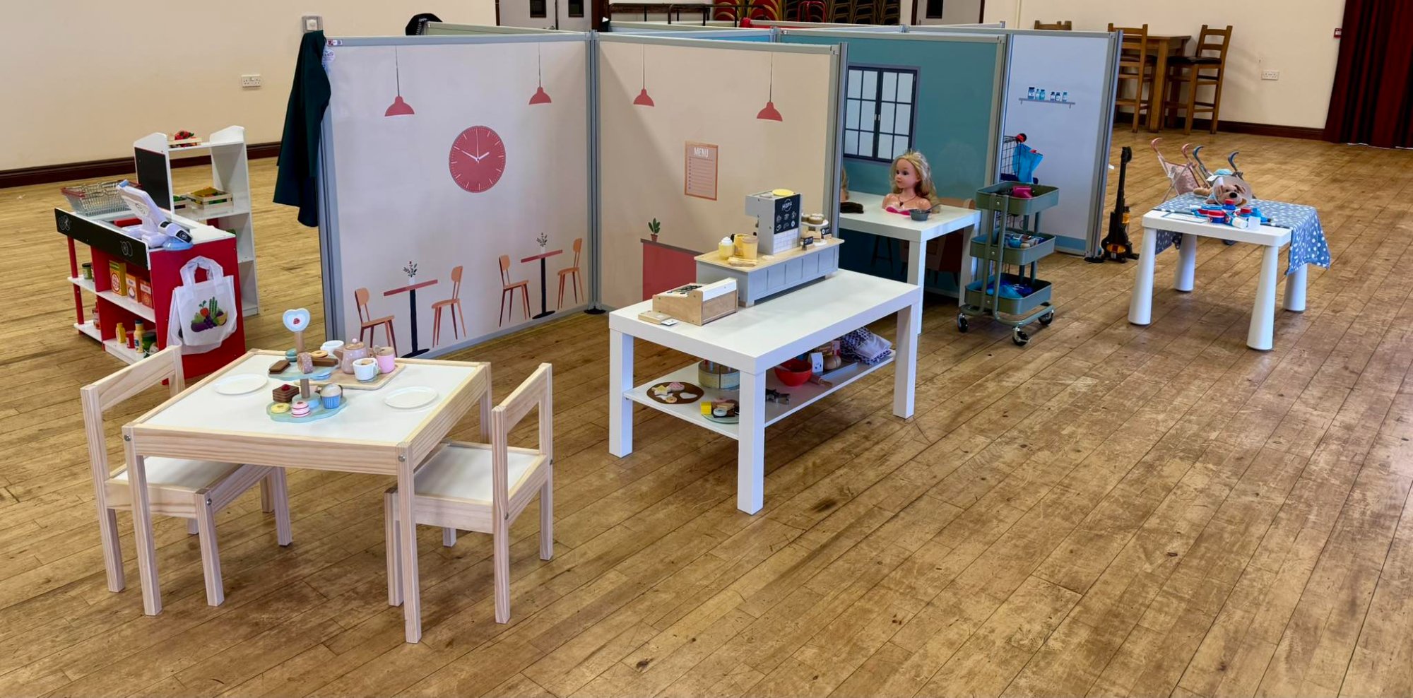 Toddler Town pop-up role play setup showing the cafe, supermarket and hair dressers rooms